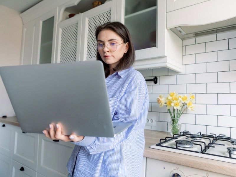 Woman on laptop in the kitchen